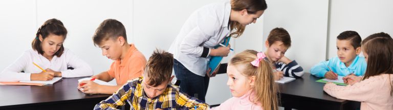 Teacher and young students working