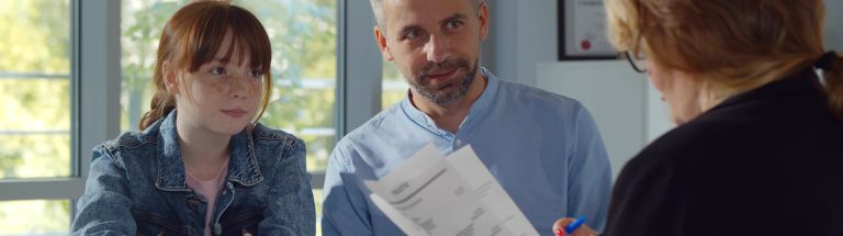 Teacher talking with parent and student